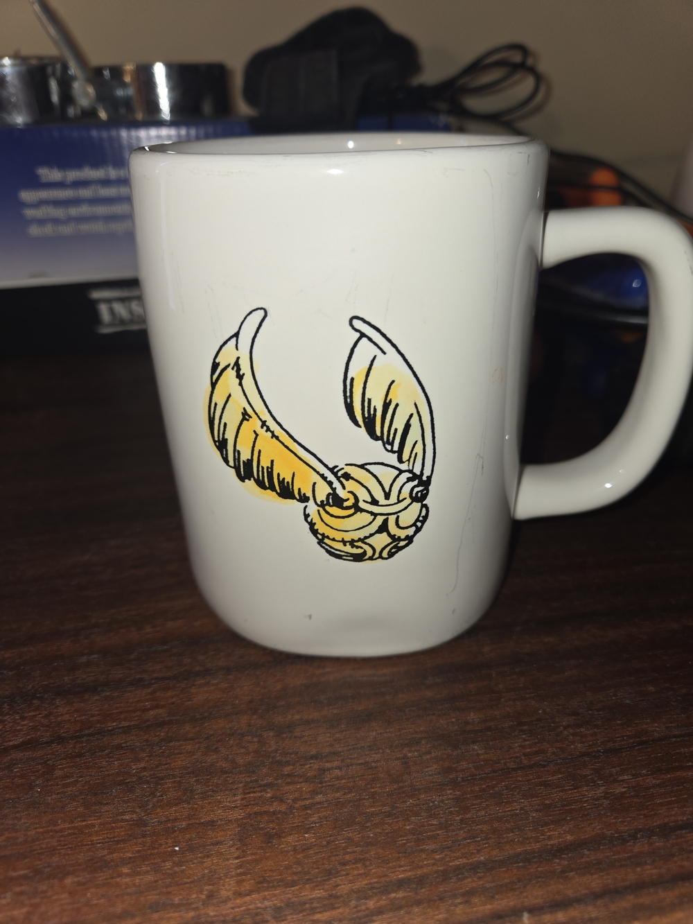 Rae Dunn White Mug with Gold Winged Snitch Graphic
